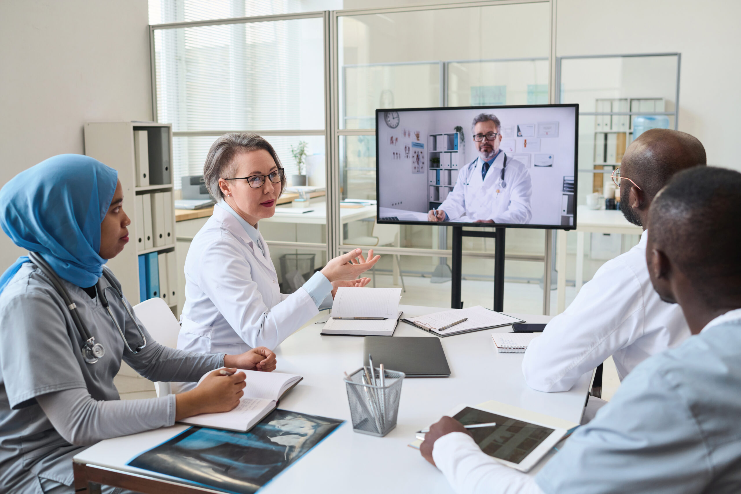 Telemedicine specialists virtually collaborating with a group of healthcare professionals