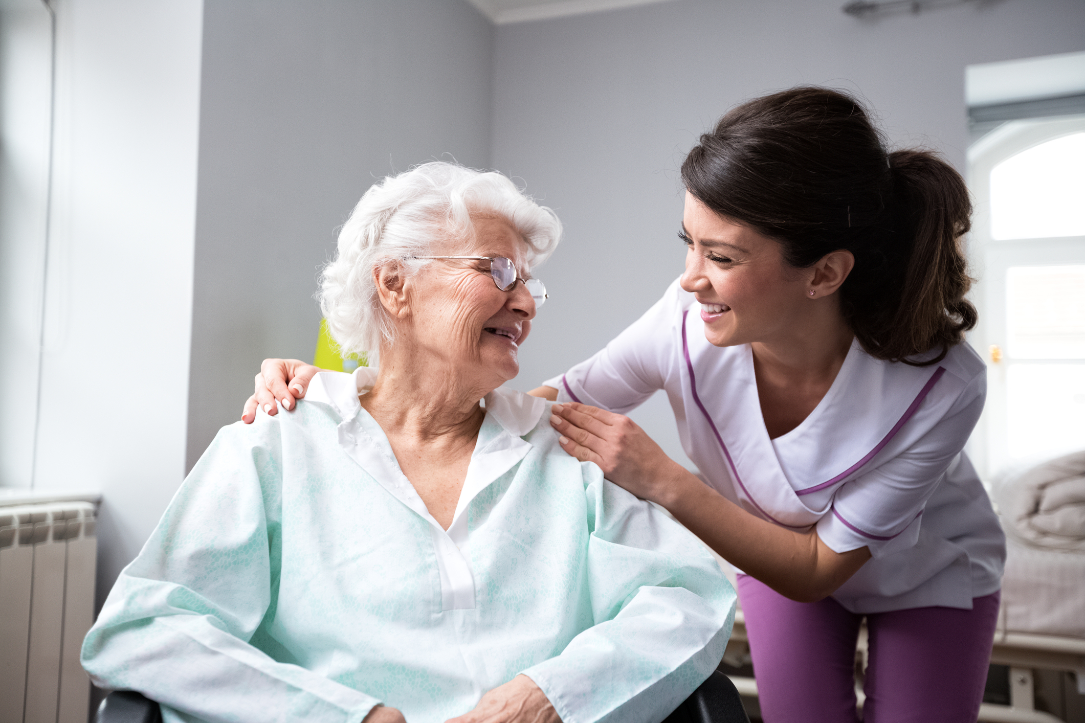 smiling nurse with happy elderly patient
